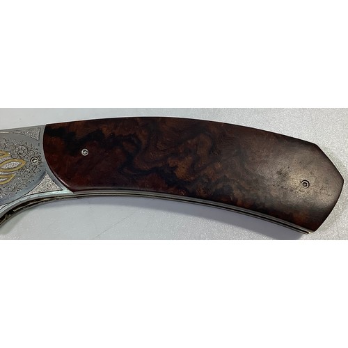 517 - A South African folding knife by John Wilmot with silver inlaid Damascus blade and wooden handle, bl... 