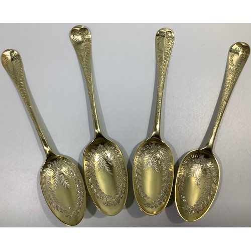 155 - A matched set of four mid-18th century silver bright-cut and later gilded berry spoons, various make... 
