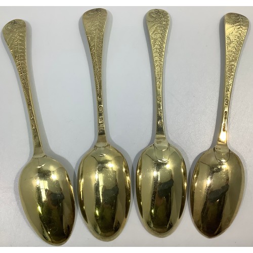 155 - A matched set of four mid-18th century silver bright-cut and later gilded berry spoons, various make... 