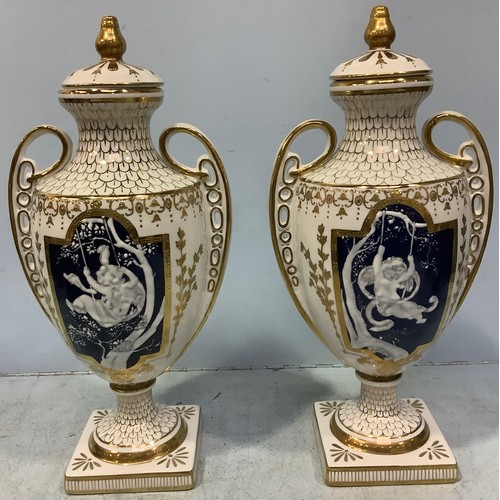 59 - A pair of pâte-sur-pâte decorated urns with covers in the style of Marc-Louis Solon, classically sha... 