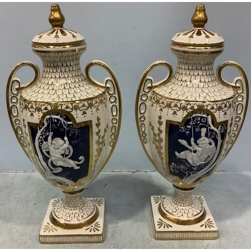 59 - A pair of pâte-sur-pâte decorated urns with covers in the style of Marc-Louis Solon, classically sha... 