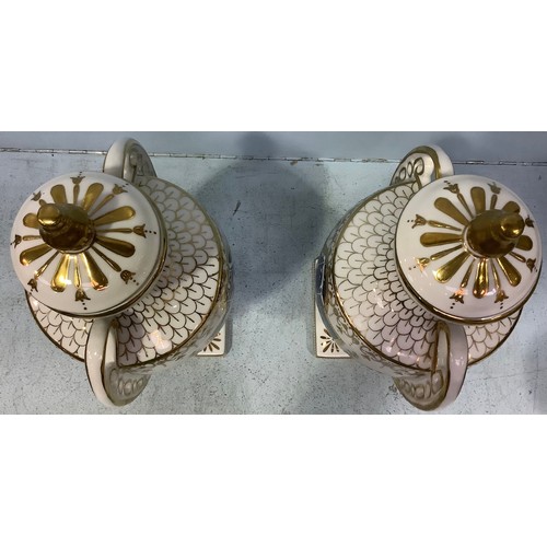 59 - A pair of pâte-sur-pâte decorated urns with covers in the style of Marc-Louis Solon, classically sha... 