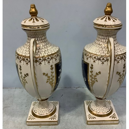 59 - A pair of pâte-sur-pâte decorated urns with covers in the style of Marc-Louis Solon, classically sha... 