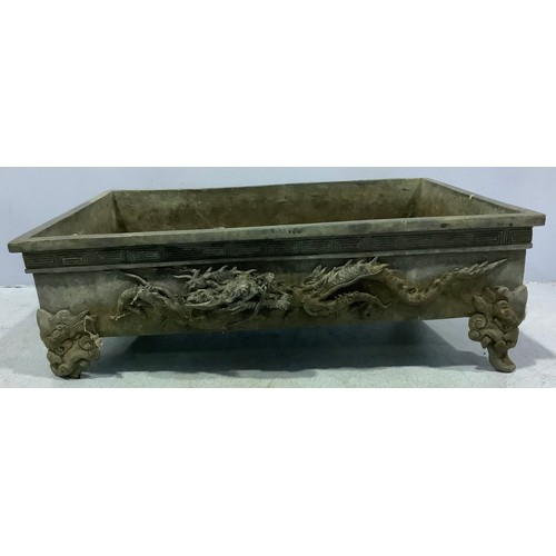 96 - A Chinese cast metal shallow planter / trough with applied dragons (one foot af)