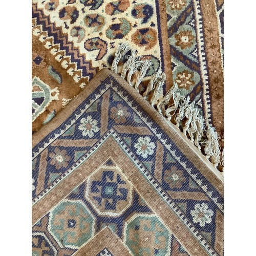 585 - A large hand-knotted Caucasian carpet with central diamond shaped medallion, decorated with birds an... 