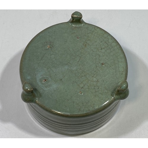 102 - A Celadon pottery tripod censor, of cylindrical form with horizontal ribbed sides and blue-tinged ce... 