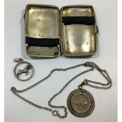 166 - A small silver cigarette case hallmarked for Birmingham, together with an Aries ram necklace pendant... 