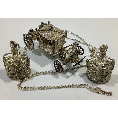 165 - A cast silver model of the British Coronation Carriage and two silver crown pendants on chains, all ... 