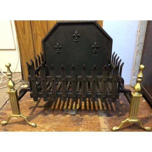 398 - A cast iron and brass fire grate, with pierced sides and bottom and solid raised back with fleur-de-... 