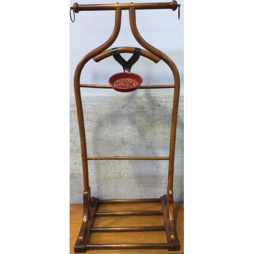 609 - A mahogany clothes/suit stand, with metal suspension rings to each side of top rail, above a metal m... 