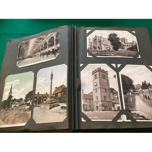 253 - A large album containing approximately 450 standard-size postcards, including English topographical,... 