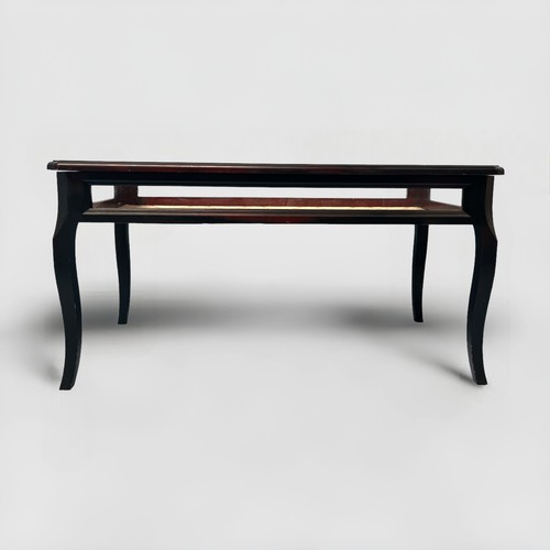 493 - A black painted bijouterie coffee table, with hinged glass top and sides, raised on squared cabriole... 