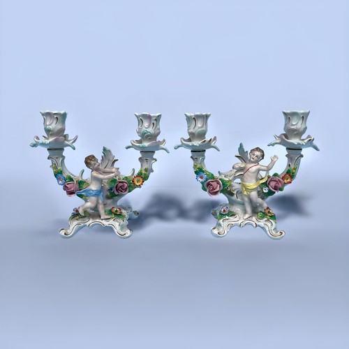 4 - A pair of  Sitzendorf porcelain two-light candelabra, of scrolled flower-encrusted design and modele... 