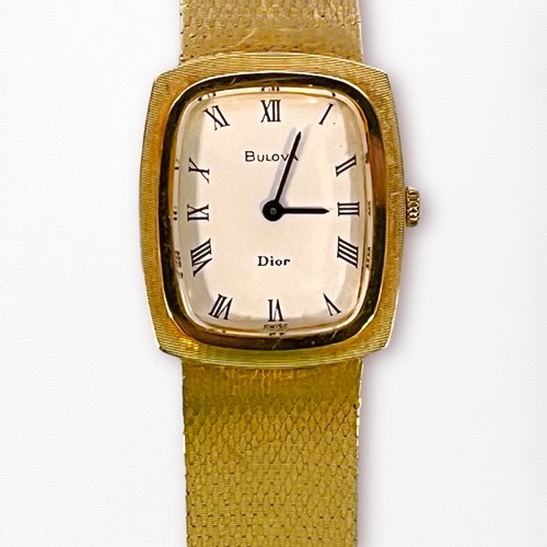 108 - A vintage 14k gold Bulova Dior wristwatch, the white enamel dial with Roman numerals denoting hours,... 