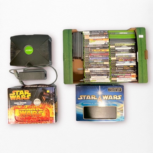 377 - An original Xbox console, with controller, power brick, and AV cables, in a Gamester satchel carry c... 