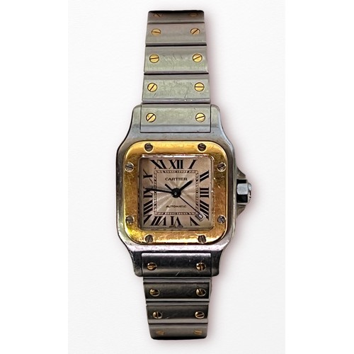 111 - A ladies stainless steel and gold automatic Cartier Santos wristwatch, model 2423, the square guillo... 