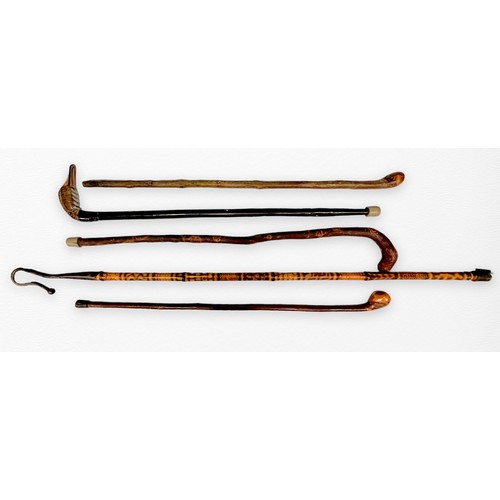 321 - Five various walking sticks including one example made from a stained bamboo flute, modelled as a sh... 