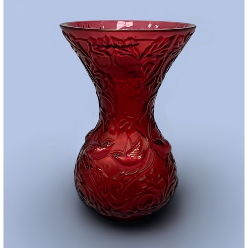 20 - A Lalique Crystal Arabesque vase in ruby, with engraved crystal birds playing amongst frosted leaves... 