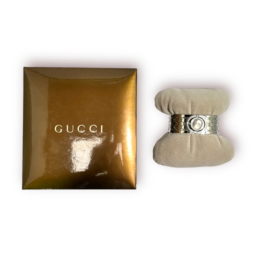 107 - A modern ladies Gucci series 112 ‘Twirl’ bangle wristwatch, with branded silvered dial, diamond set ... 