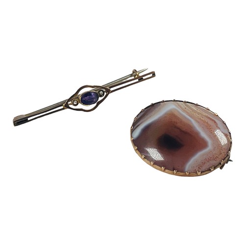 128 - A 9ct yellow gold bar brooch, set with an oval amethyst and two seed pearls to the centre, weighing ... 