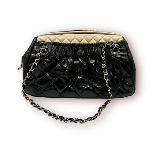 294 - A Chanel vintage black aged calfskin leather and cream quilted handbag, grey fabric interior, with c... 