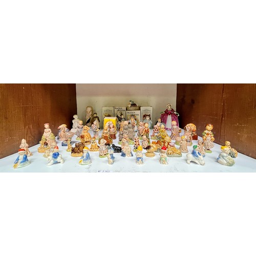 21 - A collection of fifty-two assorted Wade and Wade Ireland ceramic figures, to include, 18/20 large ‘N... 
