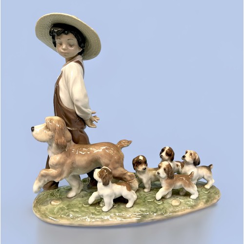 15 - A Lladro 'My Little Explorers' figure group, model no. 6828, depicting a boy in dungarees  and sun h... 