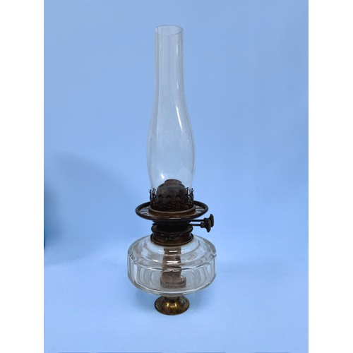 412A - A Victorian clear glass oil lamp by Williams & Bach of London, 42cm high including glass chimney