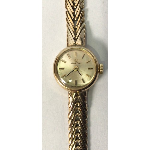 114 - A ladies 9ct gold Omega wristwatch, the circular silvered dial with applied gold batons denoting hou... 