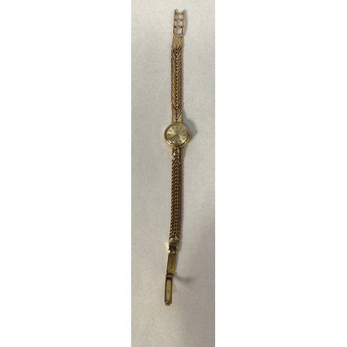 114 - A ladies 9ct gold Omega wristwatch, the circular silvered dial with applied gold batons denoting hou... 