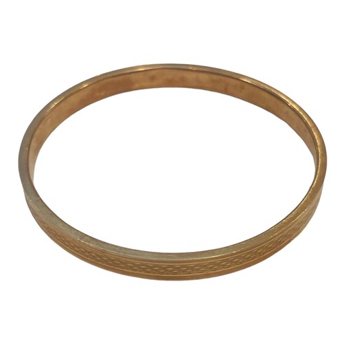 174 - A 9ct rose-gold sold bangle, weighing 10.0 grams.