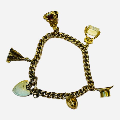 181 - A 9ct gold lady’s charm bracelet, five charms, including a top-hat, a teepee, and a helmet etc, with... 