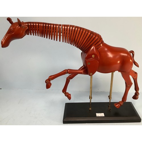 467 - An artist’s giraffe lay model or sculpture, red stained wood, on black wooden base with fully articu... 