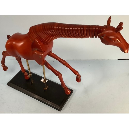 467 - An artist’s giraffe lay model or sculpture, red stained wood, on black wooden base with fully articu... 