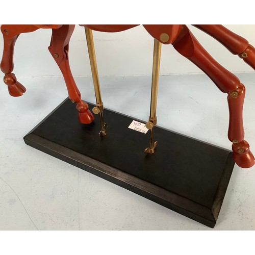 467 - An artist’s giraffe lay model or sculpture, red stained wood, on black wooden base with fully articu... 