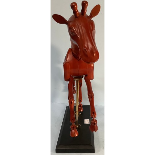 467 - An artist’s giraffe lay model or sculpture, red stained wood, on black wooden base with fully articu... 