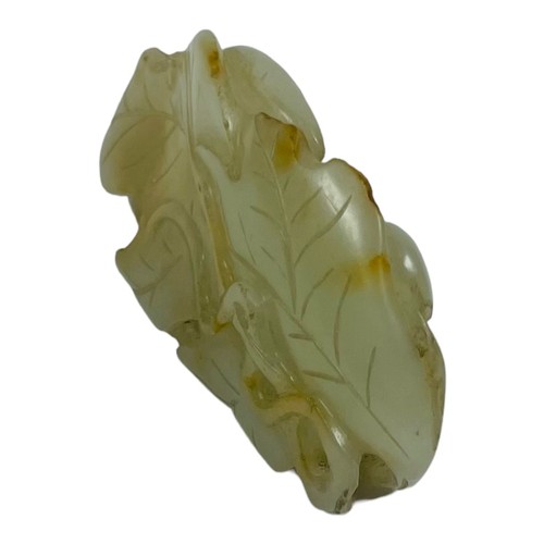 66 - A Chinese Qing Dynasty pale celadon jade 'Squirrel and Grapevine' pendant, realistically carved with... 
