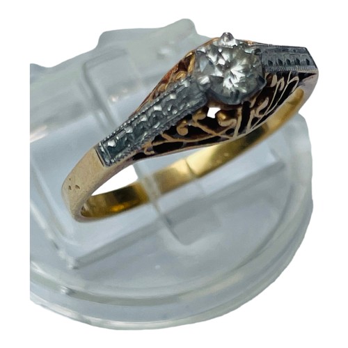 201 - An 18ct yellow gold and platinum solitaire diamond ring, high set with a band of platinum through th... 