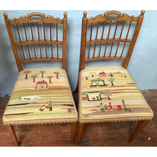 506 - A pair of walnut spindle back dining chairs by Gillows, stamped, with pastel coloured knitted seat c... 