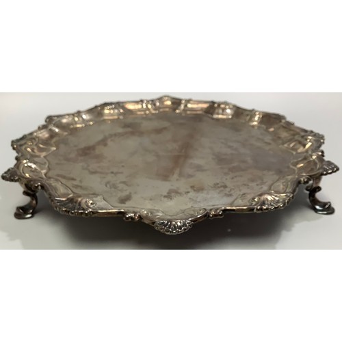 87 - A small George III silver salver by Richard Rugg I, with srpentine and shell border, bull crest to c... 