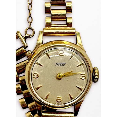 119 - A ladies 9ct gold cased Tissot wristwatch, the silvered dial with batons denoting hours and Arabic n... 