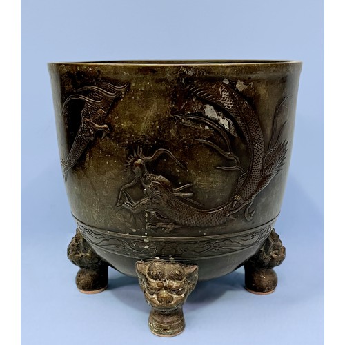 71 - A Chinese cast and patinated bronze jardiniere of circular form, cast with two dragons to the body, ... 