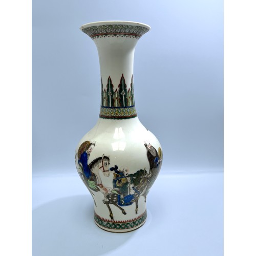 63 - A 'Wanli' Qing Dynasty porcelain Wucai vase, of baluster form with flared rim, incised and painted w... 