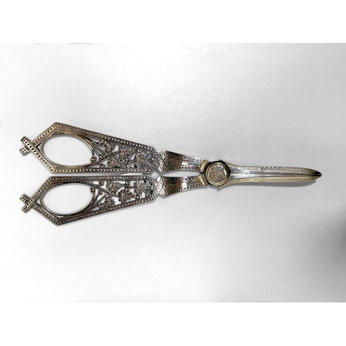 94 - A pair of 19th century silver-plated grape scissors in the 'Reformed Gothic' style, together with a ... 