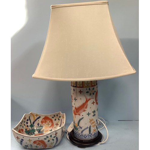 409 - A painted cylindrical lamp, modelled as a converted Oriental vase, decorated with Koi and pond plant... 