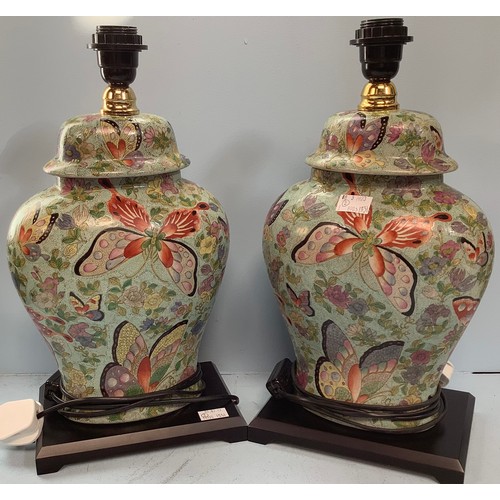 408 - A pair of Oriental brightly painted lamps, modelled as converted ginger jars and cover, decorated wi... 