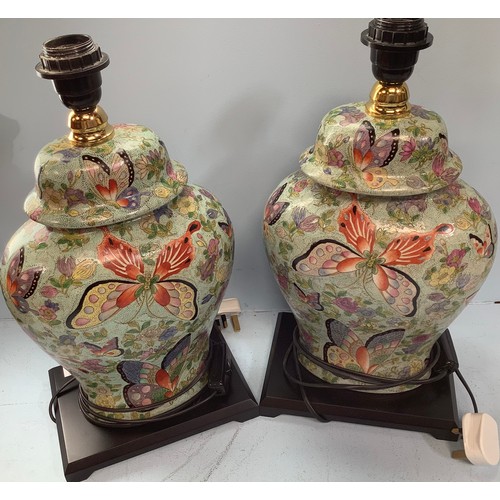 408 - A pair of Oriental brightly painted lamps, modelled as converted ginger jars and cover, decorated wi... 