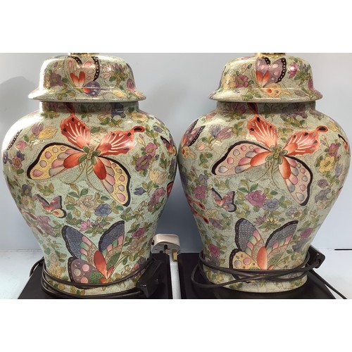 408 - A pair of Oriental brightly painted lamps, modelled as converted ginger jars and cover, decorated wi... 