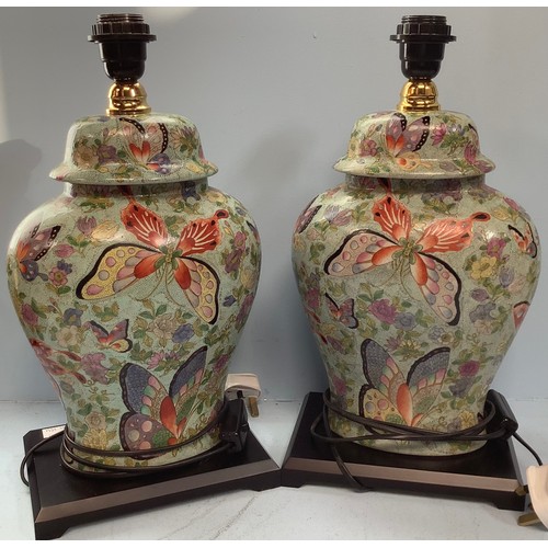 408 - A pair of Oriental brightly painted lamps, modelled as converted ginger jars and cover, decorated wi... 