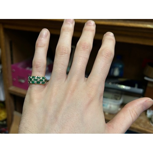 140 - An 18ct yellow gold dress ring, channel set with 13 x emeralds and 14 diamonds in a chequered design... 